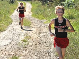 Press photo/Andy Scheidler - Ethan Stamey leads his brother Nathan by a few strides during a meet in August at Rabun Gap-Nacoochee School. The twins finished 11th and 16th at the 2-A NCHSAA Championship this past weekend in Kernersville. Franklin’s boys finished ninth, while girls placed 15th.
