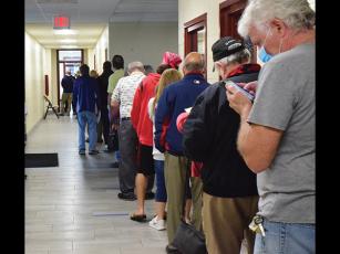 Press photo/Linda Mathias Voters line up at the Robert C. Carpenter Community Building to cast ballots in early voting.