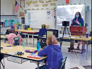 Press photo/Linda Mathias - Kim Clark teaches her third-grade class at East Franklin Elementary with nine students in the classroom and six joining in online.