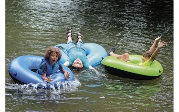 Press photos/Jake Browning - David Morales, Trevor Lujan and Marco Morales enjoy a fun day of tubing down the river at Parker Meadows on a hot summer day.