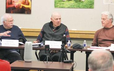 Press photo/Thomas Sherrill - Macon County Public Library Board of Trustees members Ed Trask (left) and Wood Lovell (right) go back and forth during a discussion at the board’s Dec. 5 meeting. Board Chair Bill Dyar is seated at center.