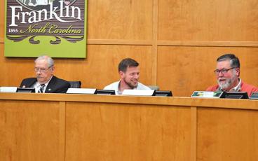 Press photo/Mia Overton - Robbie Tompa (center) took his seat for his first Town Council meeting after being elected in November. He is pictured at the Dec. 4 council meeting with Mayor Jack Horton (left) and council member Mike Lewis.
