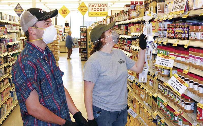 Press photo/Jake Browning - Max Falcon and Megan Nicholson wear masks to protect themselves on a shopping trip to Sav-Mor.