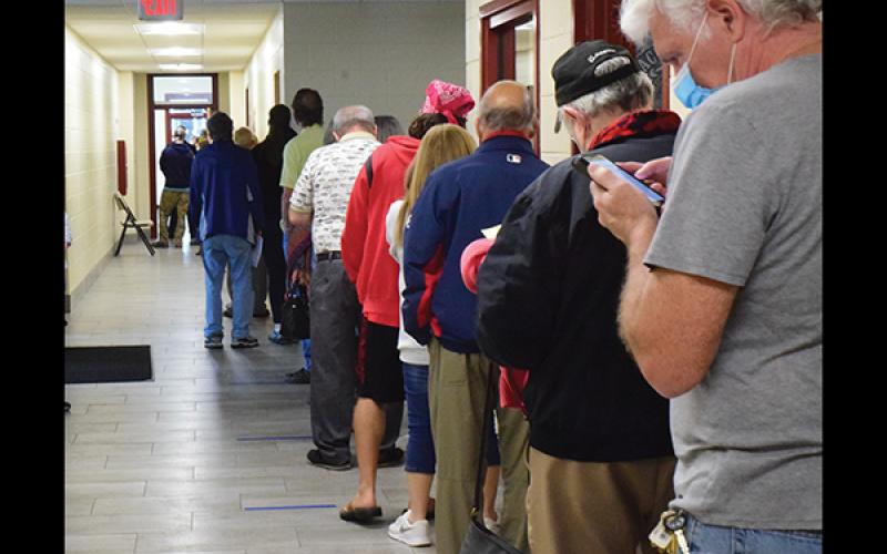 Press photo/Linda Mathias Voters line up at the Robert C. Carpenter Community Building to cast ballots in early voting.