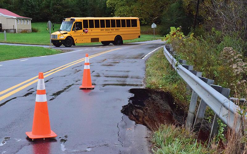 Press photo/Linda Mathis - A school bus takes a detour around a damaged section of Wells Grove Road.