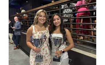 UNIFY March Madness student lead Sara Crupi (left) and Panther track and field standout Michelle Ortega show off Franklin's Commissioner's Trophies, won jointly between the two organizations, at the N.C. High School Athletic Association's Annual Awards Celebration in Greensboro June 10. (Photo submitted)