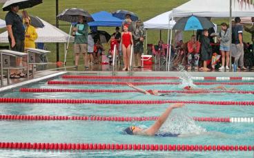 Girls aged 11-12 swim a close race under a downpour in the 200-yard individual medley June 18. Pictured from foreground are Annabelle Searles of Highlands, Hanna Samuelson of Franklin and Nyah Rivera of Franklin. (Press photo/Will Woolever)