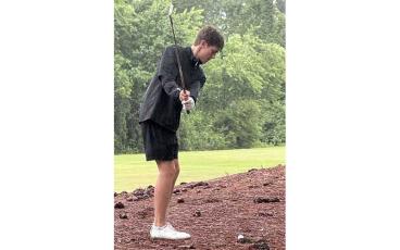 Tanner Jones lines up a shot in the pouring rain during last year's 3A State Tournament at Gates Four Golf Club in Lexington. (Press file photo)