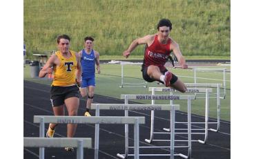 Jonas Phillips (right) competes in the 300-meter hurdles during the Mountain Eight Conference Championship meet at North Henderson April 30. (Press file photo)