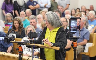 Press photo/Shelby Powell - Margaret Pickett speaks against the Macon County Planning Board's redistricting recommendation, advocating for a five-district system.