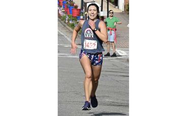 Overall female winner Chelsea Ellwood of Cullowhee nears the finish line in the Braveheart 5K. (Photo/Bob Scott)
