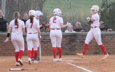 All-Conference selections (from left) Alyssa Awtrey, Chloe Lambert, Suzanna Cabe and Ashlyn McConnell mob Kendall Rumans at home plate after Rumans’ two-run homer versus Murphy March 4. (Press file photo)