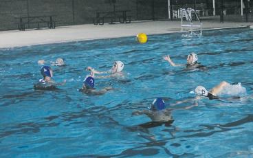 Cadee Breedlove passes the ball to a teammate during a recent FAST water polo practice. Credit: Press photo/Will Woolever
