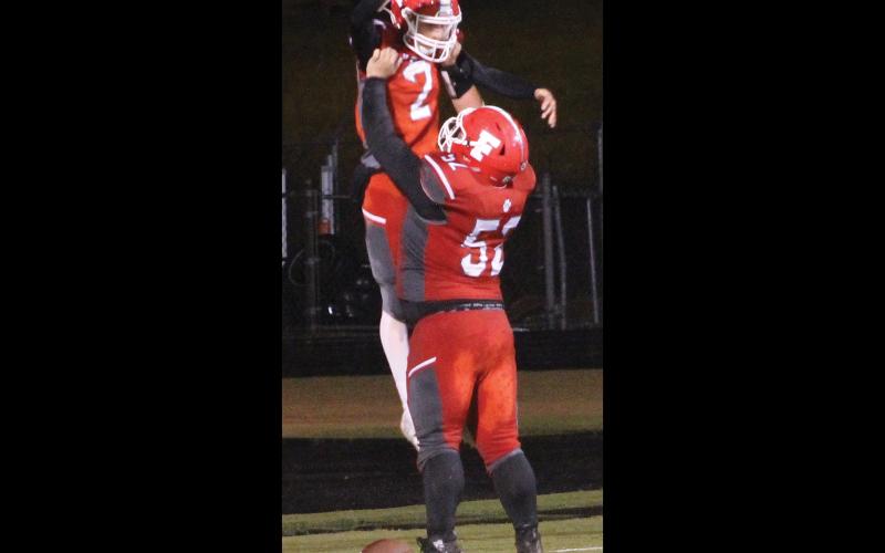 Press photo/Andy Scheidler Senior lineman Gavin Riddle celebrates with sophomore Chris McGuire after he caught a 35-yard touchdown pass on a gadget play Friday night.