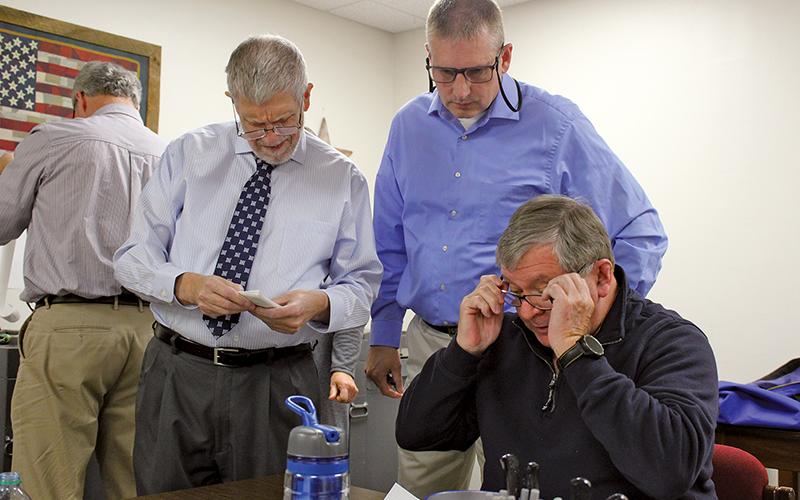 Press photo/Jake Browning Macon County Board of Elections members Jeffrey Gillette, John Vanhook and Gary Dills during the municipal election canvassing.