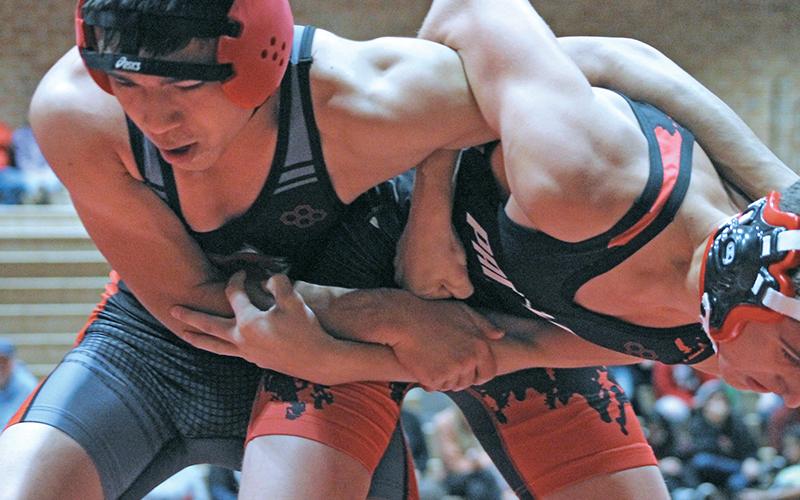 Press photo/Andy Scheidler - Aiden Carpenter (right) locks arms with an Andrews wrestler during Tuesday’s exhibition match at Macon Middle School. Carpenter, a junior, is one of three team captains for Franklin. The Panthers are set to open the season Saturday in a tournament at Swain County.