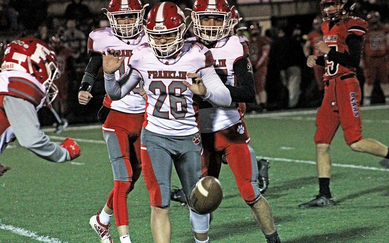 Press photo/Andy Scheidler A trio of Franklin players, including Ryan Craig (26), Devyn Blackburn (left) and Cameron Peek (right) make sure to let the ball continue rolling before touching it during Friday’s game in Canton.