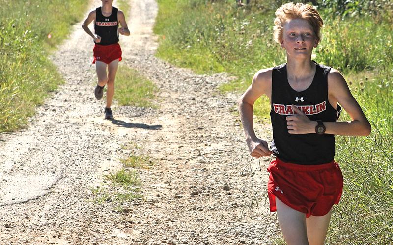 Press photo/Andy Scheidler - Ethan Stamey leads his brother Nathan by a few strides during a meet in August at Rabun Gap-Nacoochee School. The twins finished 11th and 16th at the 2-A NCHSAA Championship this past weekend in Kernersville. Franklin’s boys finished ninth, while girls placed 15th.
