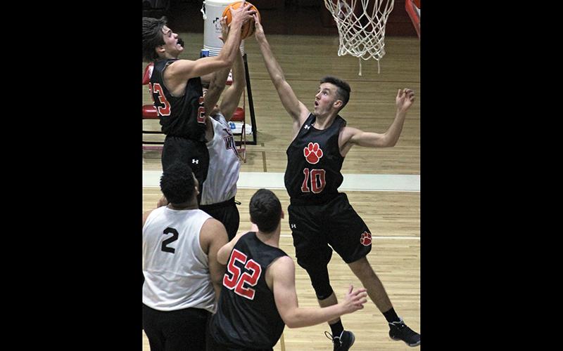 Press file photo - Franklin’s two Treys – Penland (23) and Woodard (10) – reach for a rebound in a November scrimmage against Andrews. Penland, a sophomore, scored 13 points Saturday in his first career varsity start.