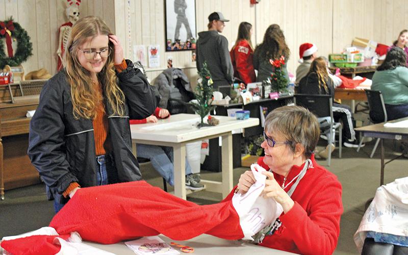 Press photo/Jake Browning - Lauren Macumber presents Leanne Webb with her Christmas stocking at Macon Citizens Habilities.
