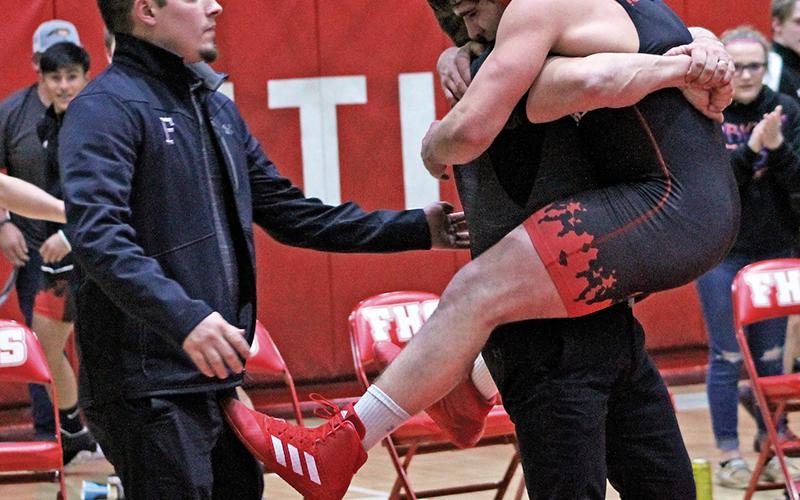 Press photo/Andy Scheidler - Braden Berger jumps into the arms of assistant coach Bill Barrington, while head coach Kyle Barrington also celebrates with the junior. Berger beat Smoky Mountain’s Will Frady for the first time in eight matches.