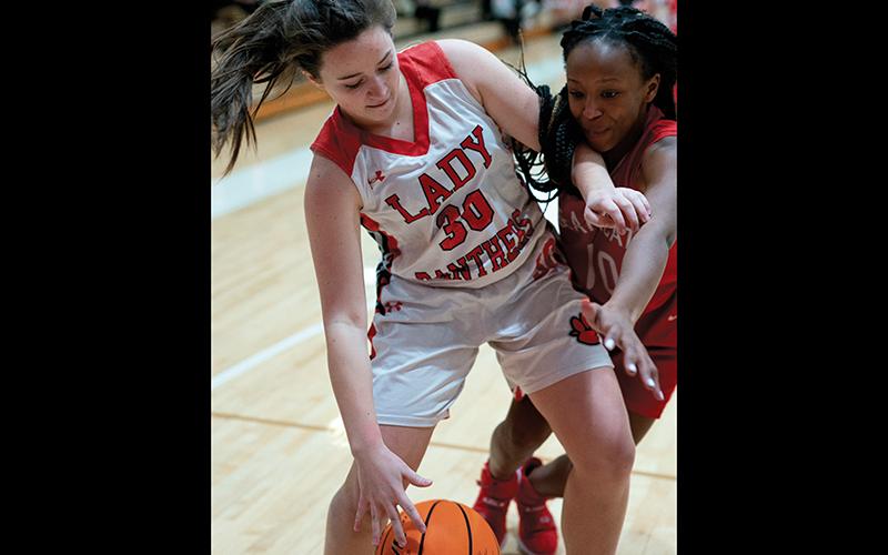 Press photo/Tom Pantaleo Abby Carpenter shields off a Hendersonville player reaching for the ball during Friday’s tournament game.