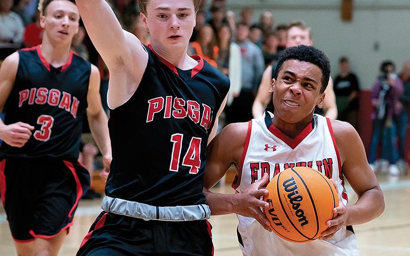 Press photos/Tom Pantaleo - Chad Wilson drives to the hoop while Pisgah’s Max Wait tries to cut him off during action Friday. Franklin avenged a 53-30 loss to the Black Bears by winning another low-scoring battle, 46-43.