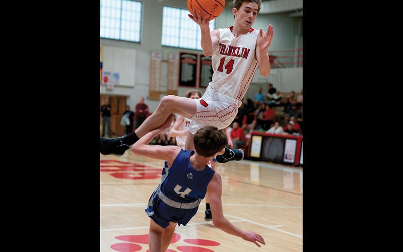 Press photo/Tom Pantaleo Franklin’s Devyn Blackburn gets some serious elevation while a Brevard player tries taking a charge. Fortunately, neither player got injured on the collision.