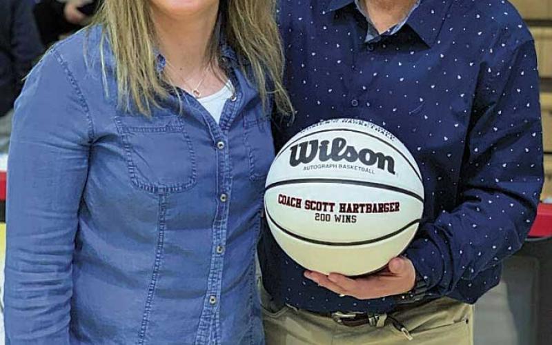 Photo provided - Franklin’s all-time leading scorer Lindsay Simpson presented a 200 wins ball to coach Scott Hartbarger.