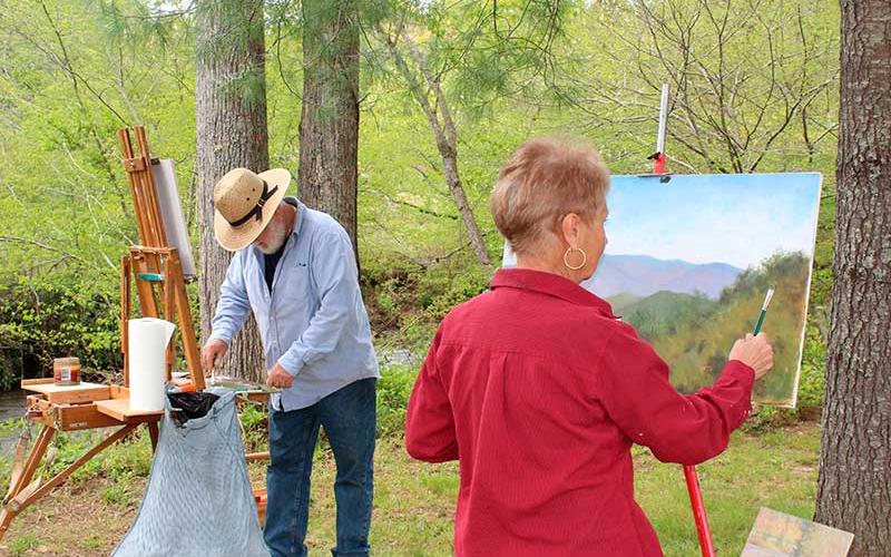Press photo/Jake Browning - Jon Houglum and Sally Mass paint along Cartoogechaye Creek at Parker Meadows.
