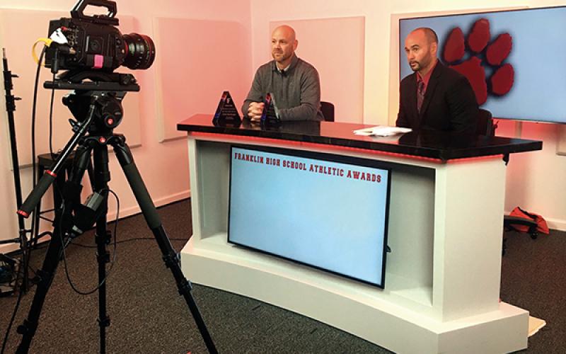 Press photo/Andy Scheidler - Franklin High School athletic director Blair King (right) and assistant athletic director Ryan Haley record a video presentation May 20 at Backlot Cinema for the annual Athletic Awards ceremony.