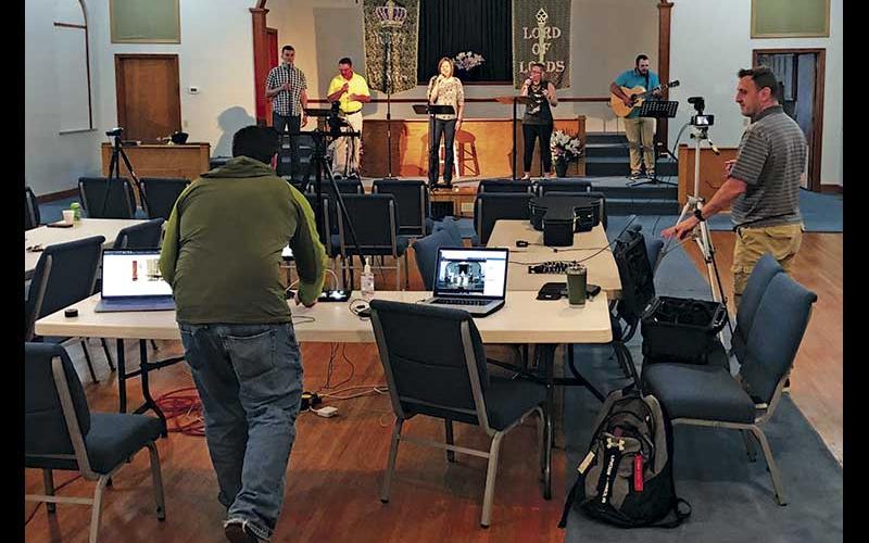 Photo submitted - Daniel Rogers (left) and Lee Cloer work the computers during a live-streamed service at Holly Springs Baptist Church.