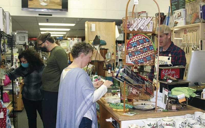 Press photo/Jake Browning - Rob Reale (right) works with customer Monica Collier at Kitchen Sink in downtown Franklin on Saturday, May 9.