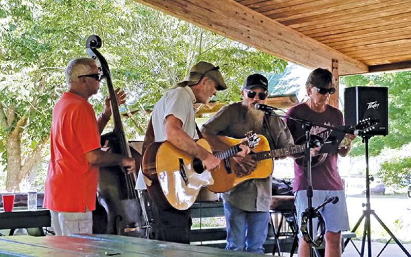 Photo submitted - Local musicians (from left) Ron Van Beuning, Chuck Dorling, Jay Baird, Dave Stewart play a concert under the Big Bear shelter at the Little Tennessee River Greenway recently. For the past few months Macon Music has hosted weekly music gatherings at the greenway.