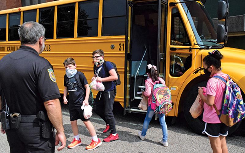 Press photo/Linda Mathias - Tom Pruett, school resource officer at East Franklin Elementary, watches as students board buses.