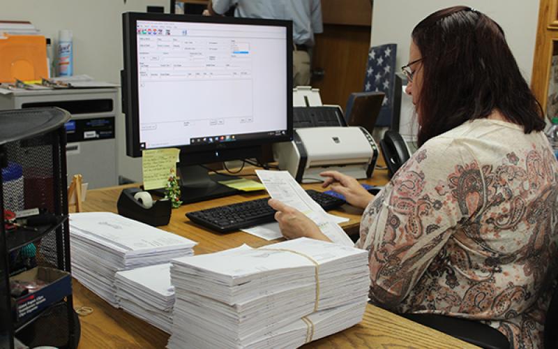 Press photo/Jake Browning - Judy Fritts with the Macon County Elections Office inputs the names of voters whose absentee ballots have already been received. As of Monday, Oct. 12, the elections office had received 4,319 requests for absentee ballots and had 2,173 completed ballots returned.
