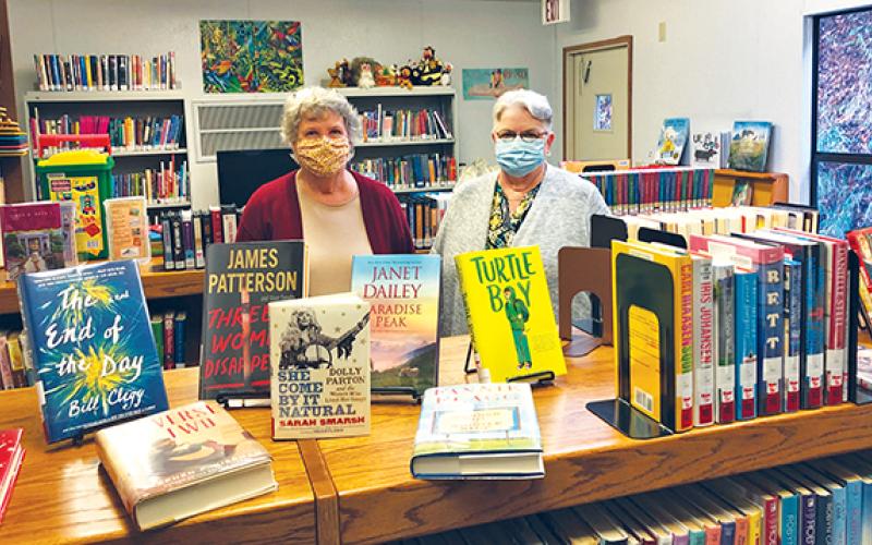 Press photo/Lee Buchanan Librarians Sharon Crosby (left) and Peggy Ellison are shown in the book section of the library.