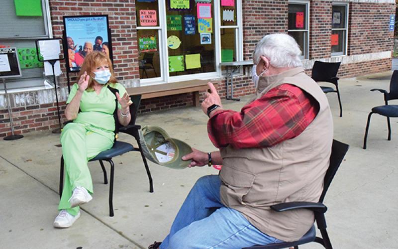Press photo/Linda Mathias - Veteran William Talbott talks with clinic LPN Tammy Godforey.