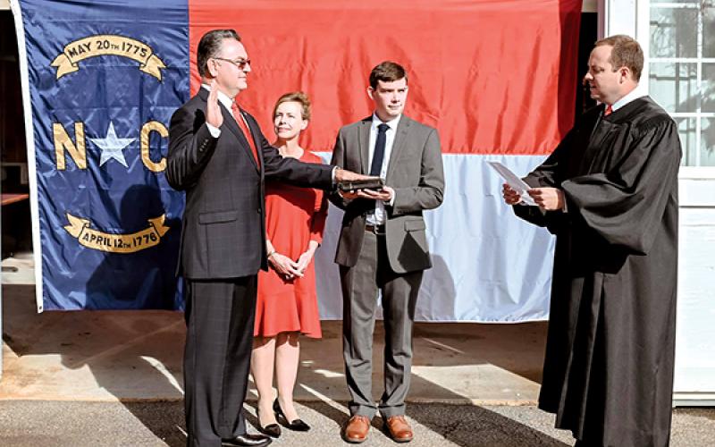 Photo submitted - Karl Gillespie was sworn in as the NC House representative for the 120th district by newly elected 30th District Court Judge Kaleb Wingate as Gillespie’s wife, Janet, and son, Logan look on.