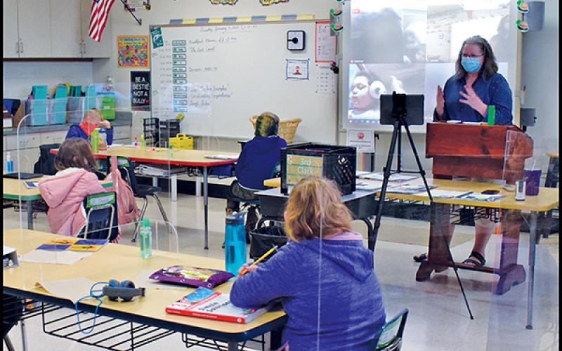 Press photo/Linda Mathias - Kim Clark teaches her third-grade class at East Franklin Elementary with nine students in the classroom and six joining in online.