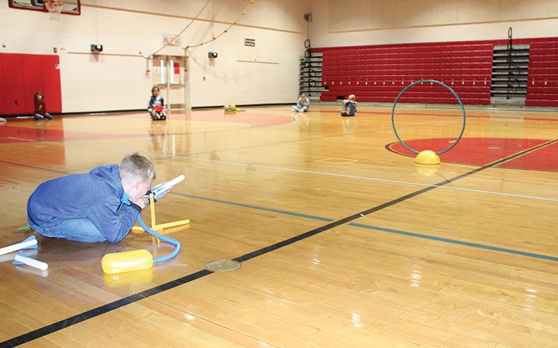 East Franklin Elementary School third grader Levi Johnson learns a lesson on trajectory by firing an air-propelled rocket through a hoop.