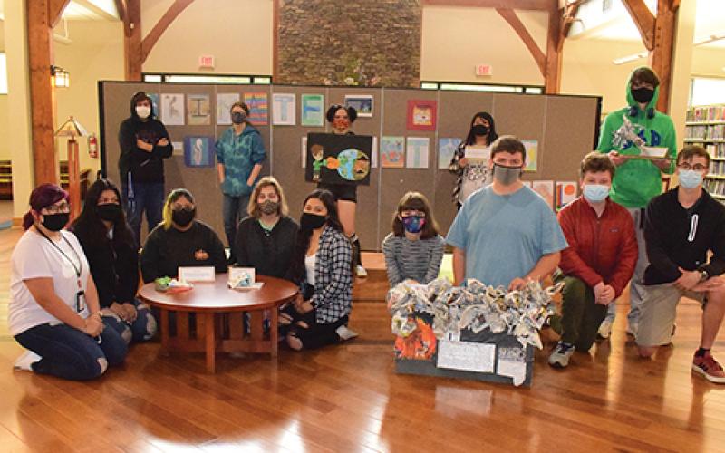 Press photo/Linda Mathias Ninth grade students in the Earth Environmental Science class at Macon Early College used art to demonstrate ideas about climate change and solutions. Their art is on display at the Macon County Public Library through June.
