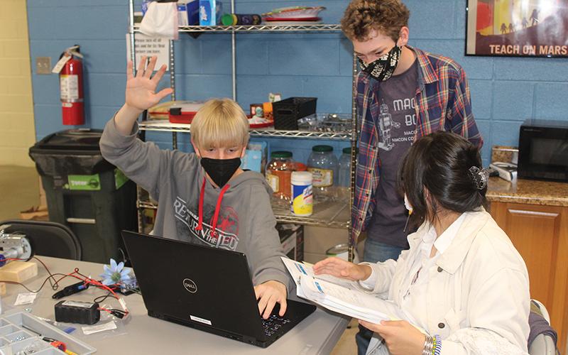 Press photo/Jake Browning - Hunter Kroeger, Jude McIntee and Giuliana Mendoza during a meeting of the Macon Bots robotics team.
