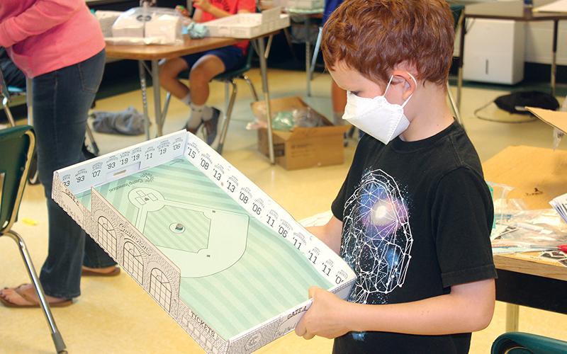 Press photo/Jake Browning - Keegan McKinley with a game board he designed himself as part of Camp Invention.