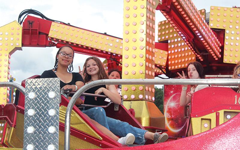 Press photos/Jake Browning - Mya Crisp and Lexi Hoyt take a whirl at the Shriners Carnival, which continues through June 12.