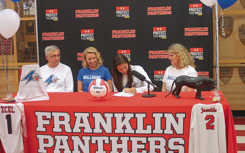 Press Photo/Will Woolever - FHS senior and volleyball standout Amy Tippett signs her official offer from UNC-Asheville as dad Steve, sister Brooke, and mom Kelli look on.