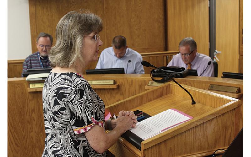 Press photo/Jake Browning - KIDS Place executive director Alisa Ashe addresses the Macon County Board of Commissioners about cuts to the Victims of Crime Act Fund.