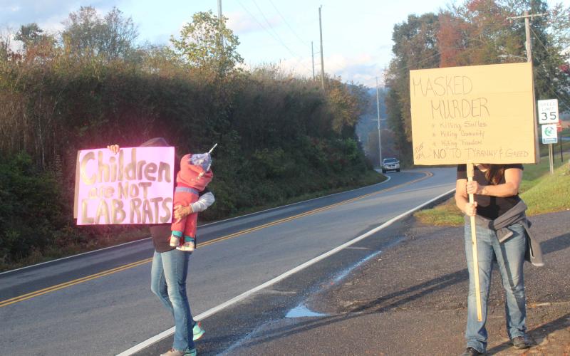 People protesting the use of face masks in schools prior to the Oct. 25 School Board meeting. The school board voted Monday night to make masks optional due to the decline in active cases in the schools and the community.