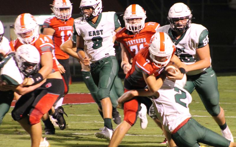Press Photo/Will Woolever - Senior tailback/defensive back Kellen Stiles tries to shed a tackle against East Henderson Sept. 17. Stiles earned Wayah Insurance Player of the Game honors against North Henderson with 119 all-purpose yards,  two touchdowns, and a fumble recovery.