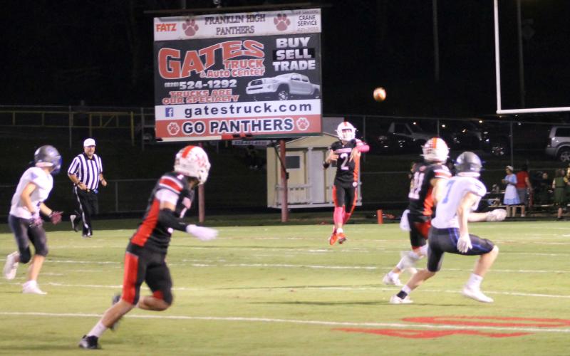 Press Photo/Will Woolever - Senior quarterback Chris McGuire attempts a pass for senior receiver Keagan Pollock against Smoky Mountain Oct. 15. Senior Grant Adams (right) occupies a Mustang defender away from the throw.